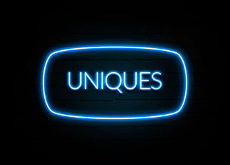 Uniques  - colorful Neon Sign on brickwall