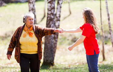 Fototapeta na wymiar Elderly woman and young caregiver