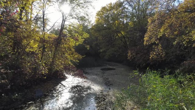 Aerial view over an Off-road vehicle crossing a river in speed.