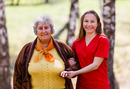 Elderly woman and young caregiver