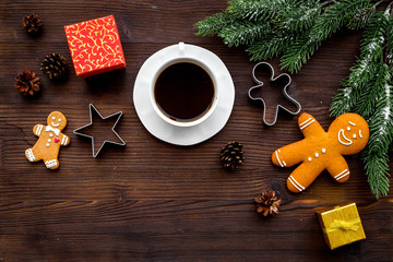 Coffee with gingebread cookies and gifts in christmas evening. Dark wooden background top view copyspace