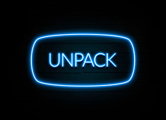 Unpack  - colorful Neon Sign on brickwall