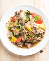 Spicy stir fried pork stips with pepper chilli on wood,thai food