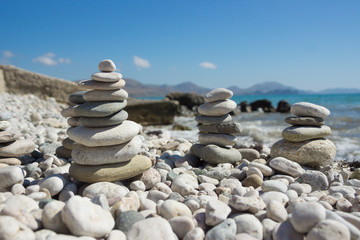 Pyramid of pebbles on a sea beach.