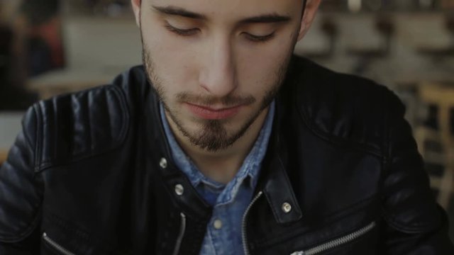 Handsome man eating tasty sushi in cafe 4K