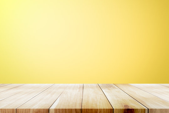 Empty wooden deck table over yellow wallpaper background. Stock Photo |  Adobe Stock