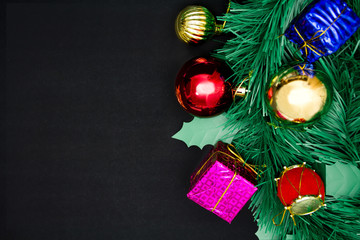 Gift boxes with decoration objects for Christmas day on black background