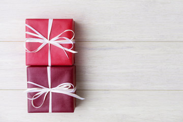 Two gift boxes over wooden background