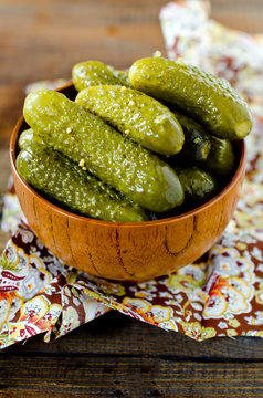Pickled cucumbers in a wooden bowl