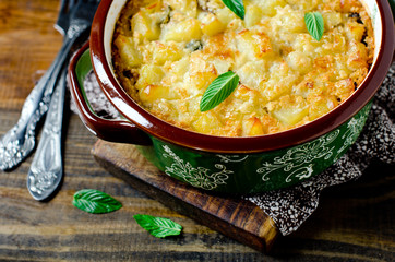 Potato casserole with meat, mushrooms and pickled cucumbers