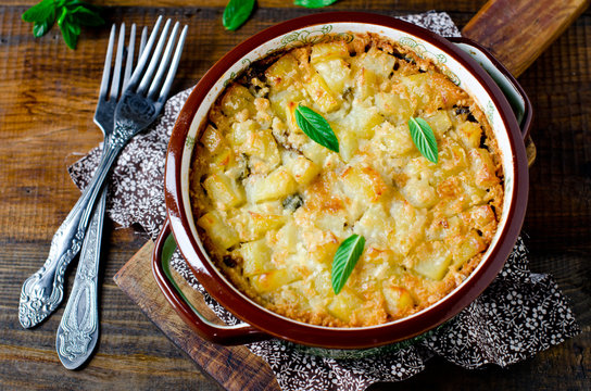 Potato casserole with meat, mushrooms and pickled cucumbers