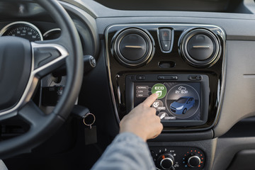 Woman using the car instrument panel