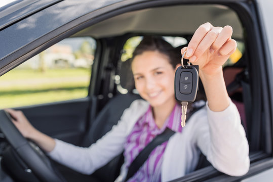 Woman holding her new car keys