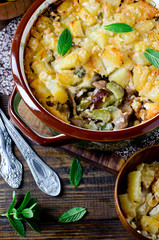 Potato casserole with meat, mushrooms and pickled cucumbers