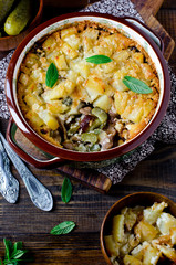 Potato casserole with meat, mushrooms and pickled cucumbers