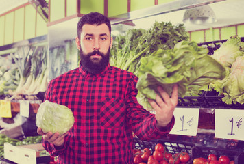 Young male seller offering salad