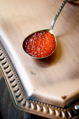 Red caviar inside metal spoon