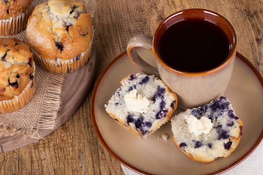 Sliced Blueberry Muffin and Cup of Coffee on a Plate