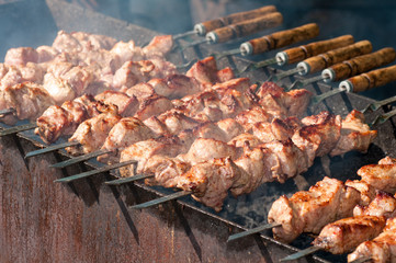 skewers fried meat on a grill