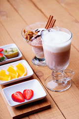 Coffee latte, ice scream and sliced fruits 