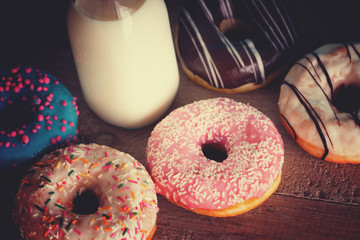 Baked donuts and glass jar with milk 