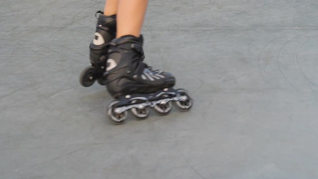 Legs in roller skates. Black roller skates.