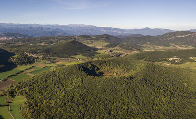Aerial view of Garrotxa Volcanic Zone Natural Park and Santa Margarida Volcano in the foreground