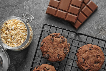 Delicious oatmeal cookies with chocolate chips on metal grid
