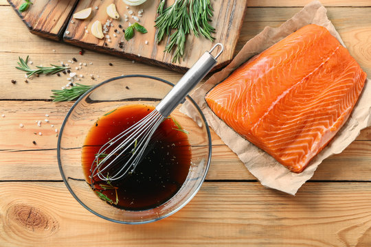 Soy marinade for salmon and fillet on wooden table
