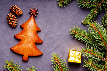 Fototapeta na wymiar Christmas handmade cookie of fir tree shape, spice and festive decor
