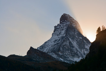Sun hiding behind the Matterhorn peak