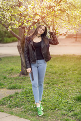girl outdoors, portrait in blooming trees. woman in flowers.