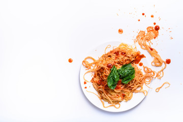Italian pasta on a plate, spaghetti cooked with tomato sauce.