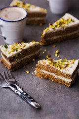 Paleo raw vegan pistachio carrot cake with cashew cream layers. Dark food photography concept