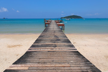 Fototapeta na wymiar Old wooden pier on exotic beach island