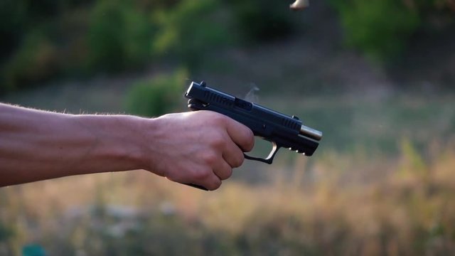 Gun shot in slow motion with sound of a shot.