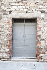 Fototapeta na wymiar Gubbio, Perugia, Italy - entrance door, architectural details of the ancient palaces