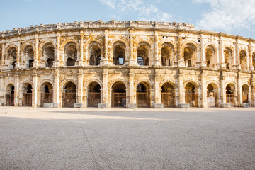 Fototapeta na wymiar Morning view on the ancient Roman amphitheatre in Nimes city in the Occitanie region of southern France