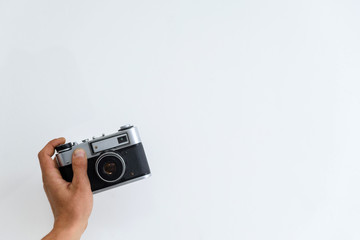 camera in hand on a white background