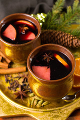 Warm mulled wine for Christmas days, prepared with apple, orange and spices.
