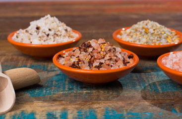 Variety of sea salt, pink Himalayan salt, colorful salt with dried chili pepper, herbs and spices.