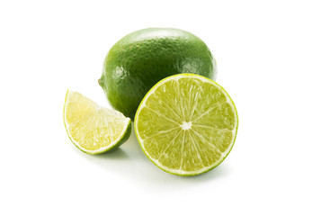 Limes with slices isolated on white background