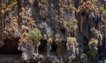 limestone rock, boat on beach island in andaman sea