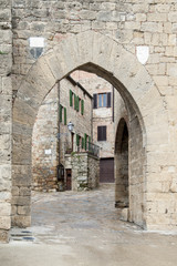 Naklejka premium Monticchiello, Val d'Orcia, Siena, Italy - entrance door to Monticchiello rises on a hill surrounded by the Siena countryside near the town of Pienza.