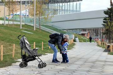 The child whispers in your ear his mother in the autumn Park
