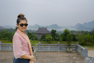 asian woman toothy smiling face standing in bai dinh temple ninh binh province vietnam