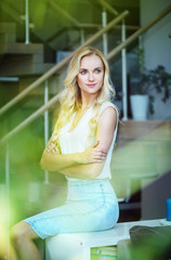 Pretty, alluring woman sitting on the couch