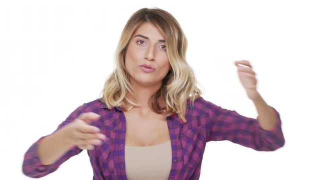 portrait of angry confident woman wearing casual clothes gesturing on camera with arms crossed expressing NO answer rejection disagreement over white background. Concept of emotions