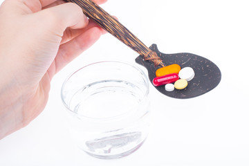 Herbal medicine in capsules from herbs on the palm of your hand for healthy living