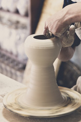 Potter makes pottery handmade in the workshop 